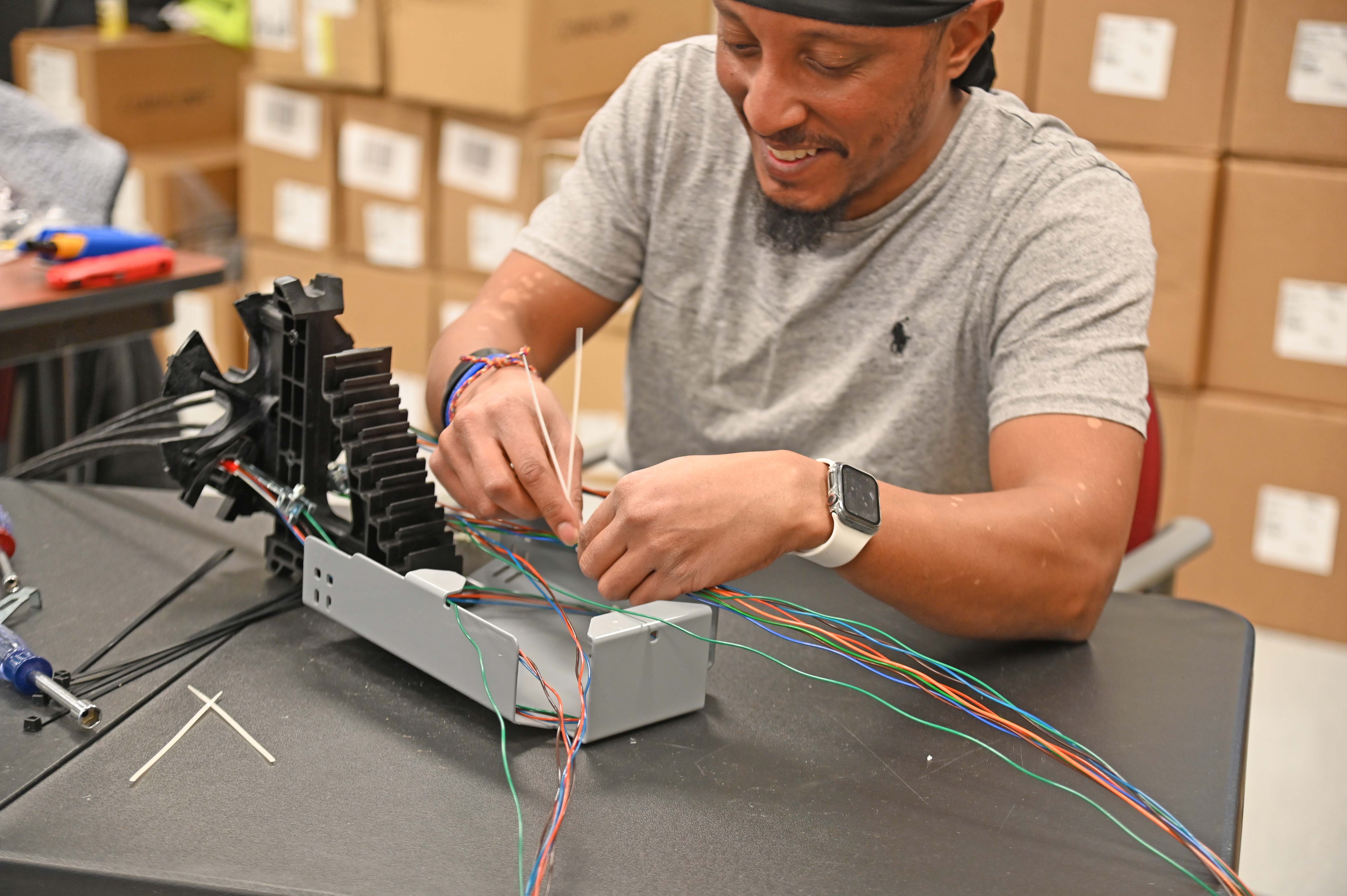 Fiber student working with wires