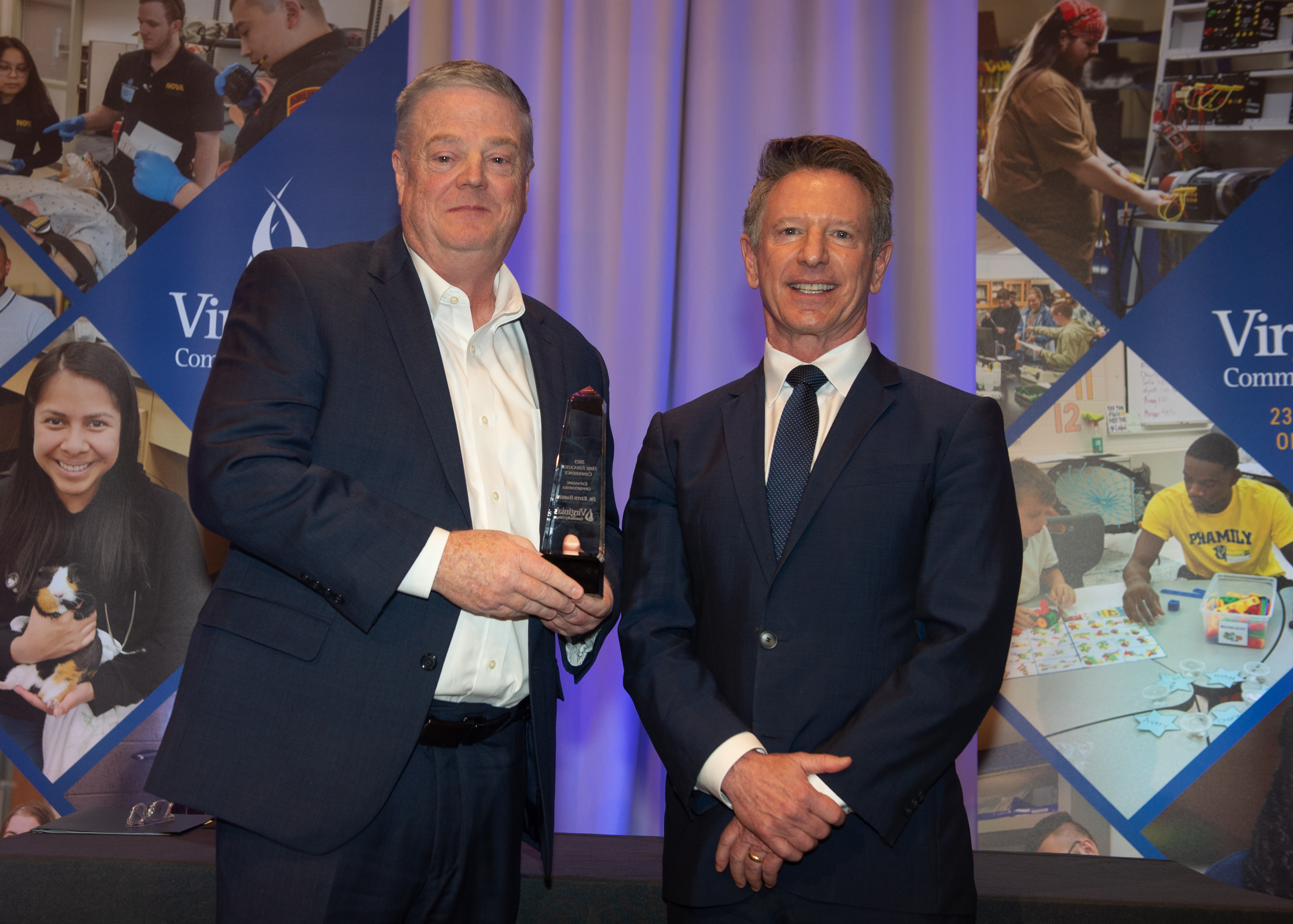 Dr. Harkins posing recieving Award from Dr. Dore on stage