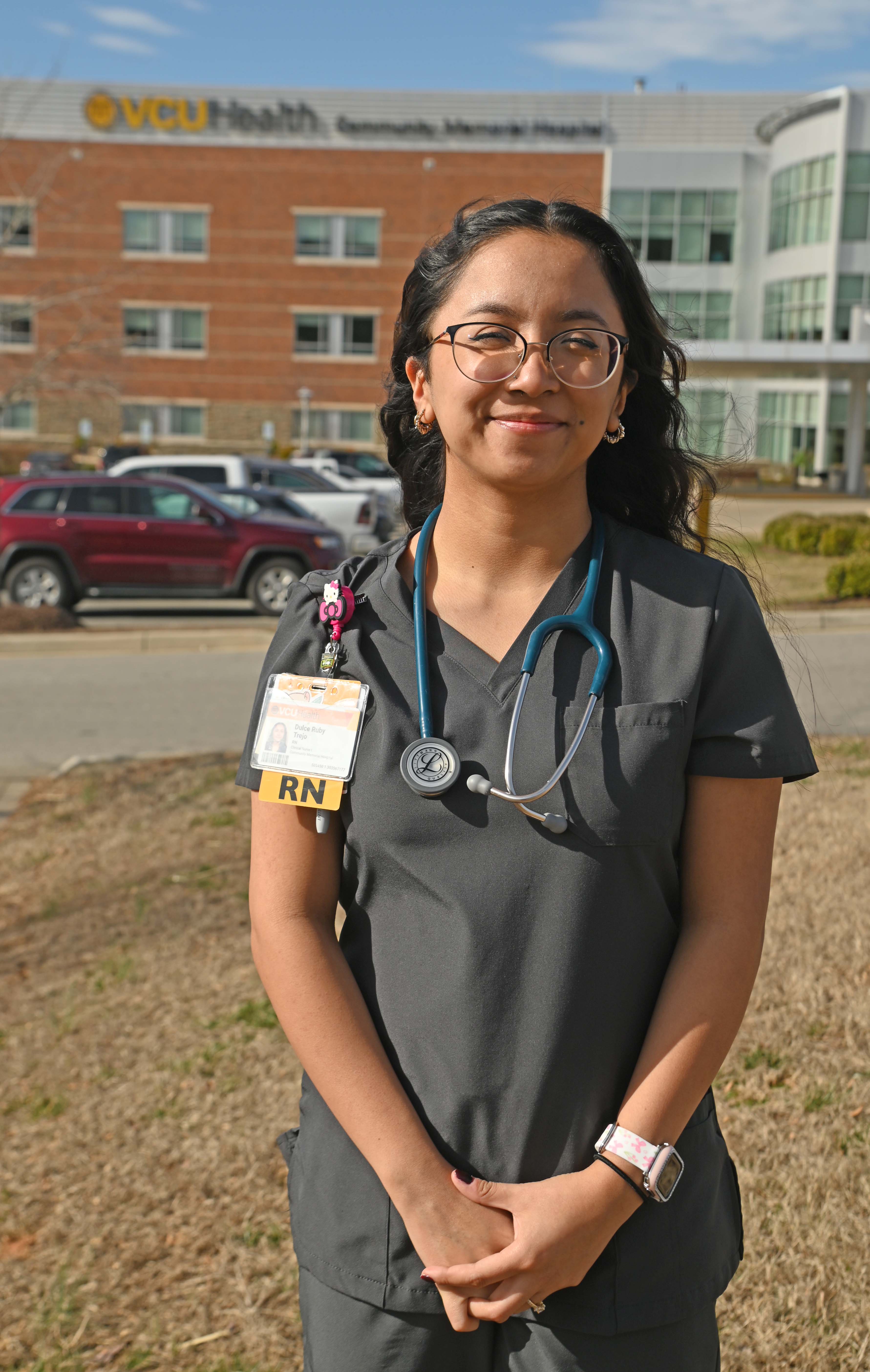Nursing graduate Ruby Trejo-Misner standing outside in front of the VCU Healthcenter