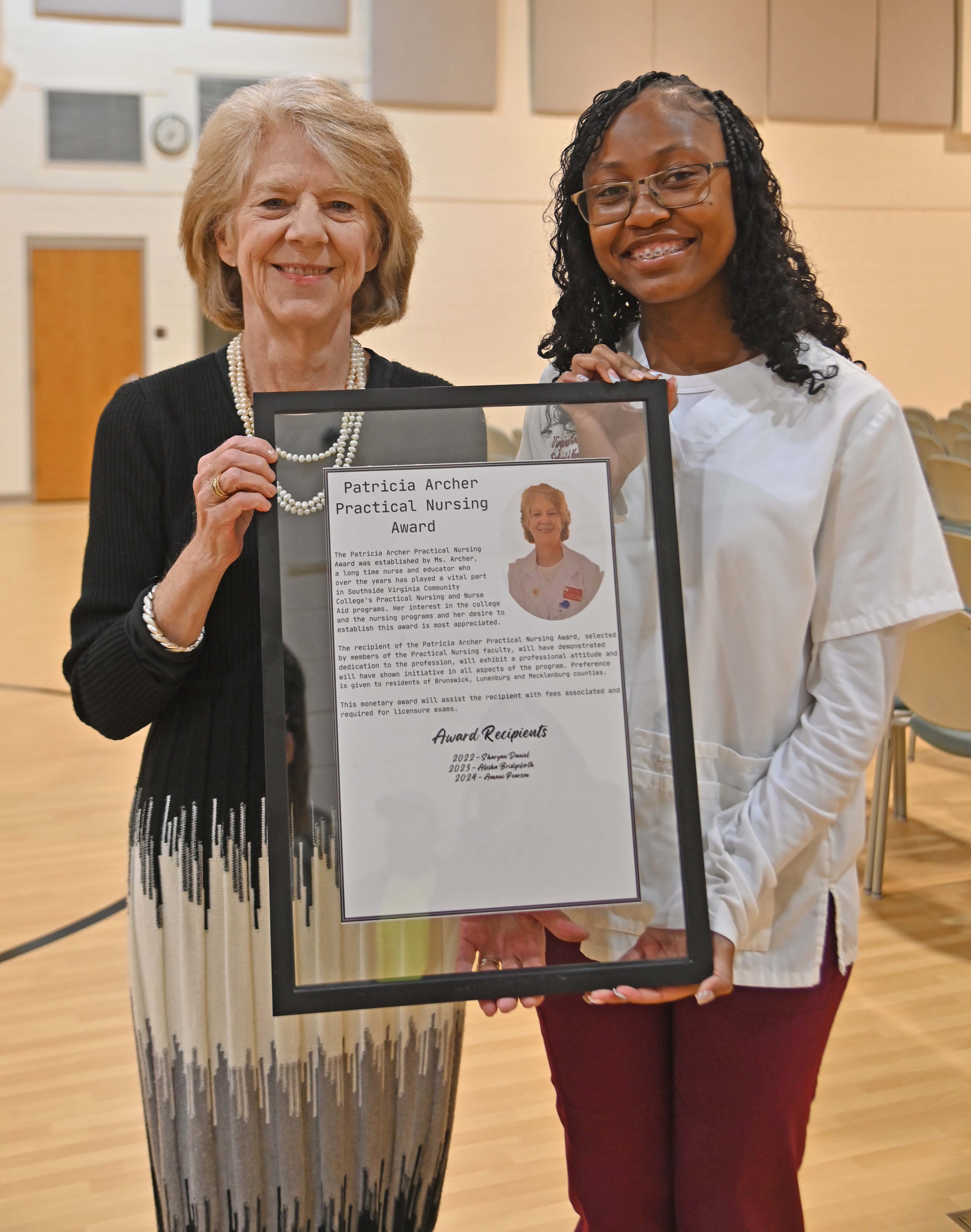 Amani Pearson accepting award from  Patricia Archer