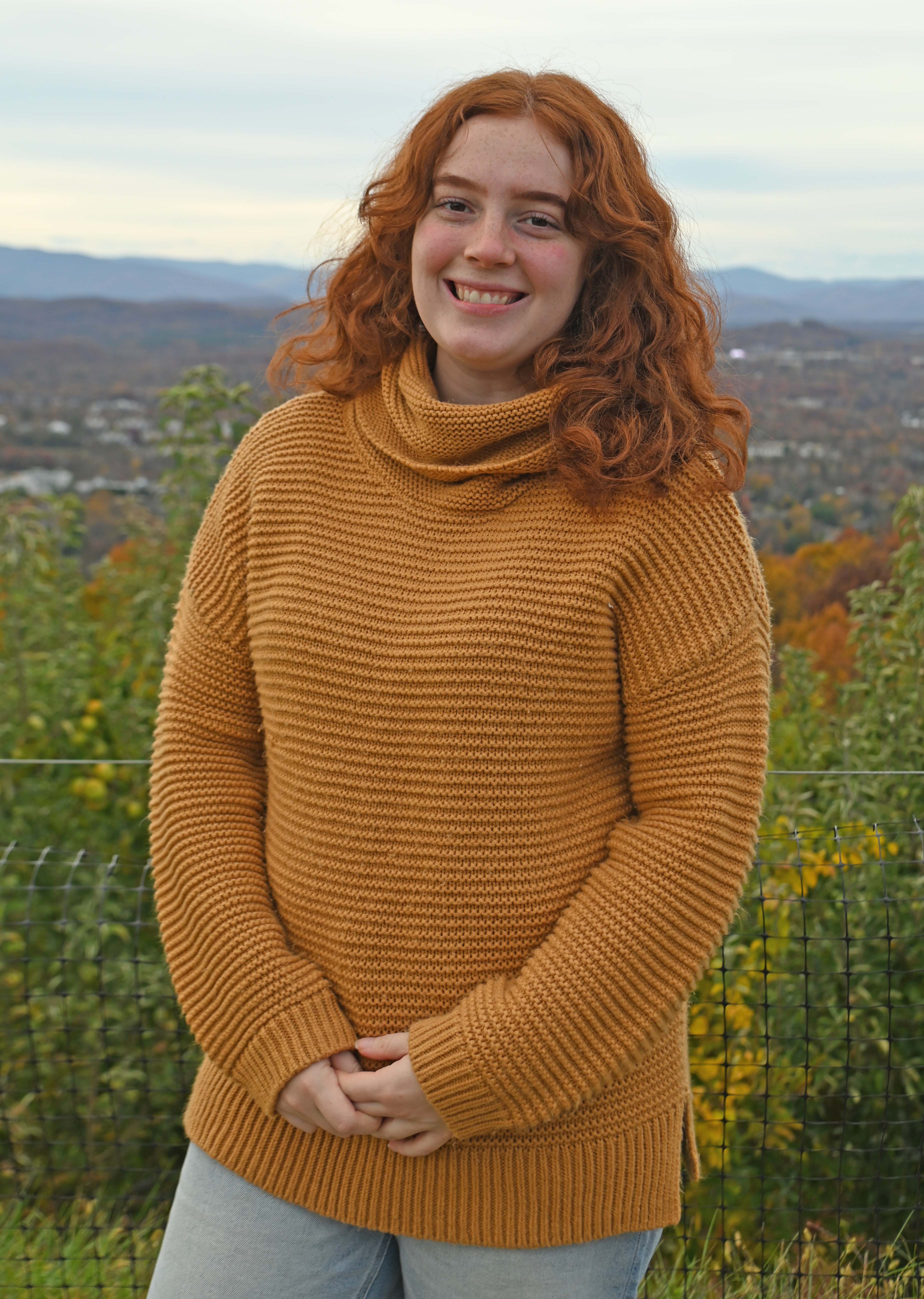 Ella Patton, young woman posing outside in front of mountains