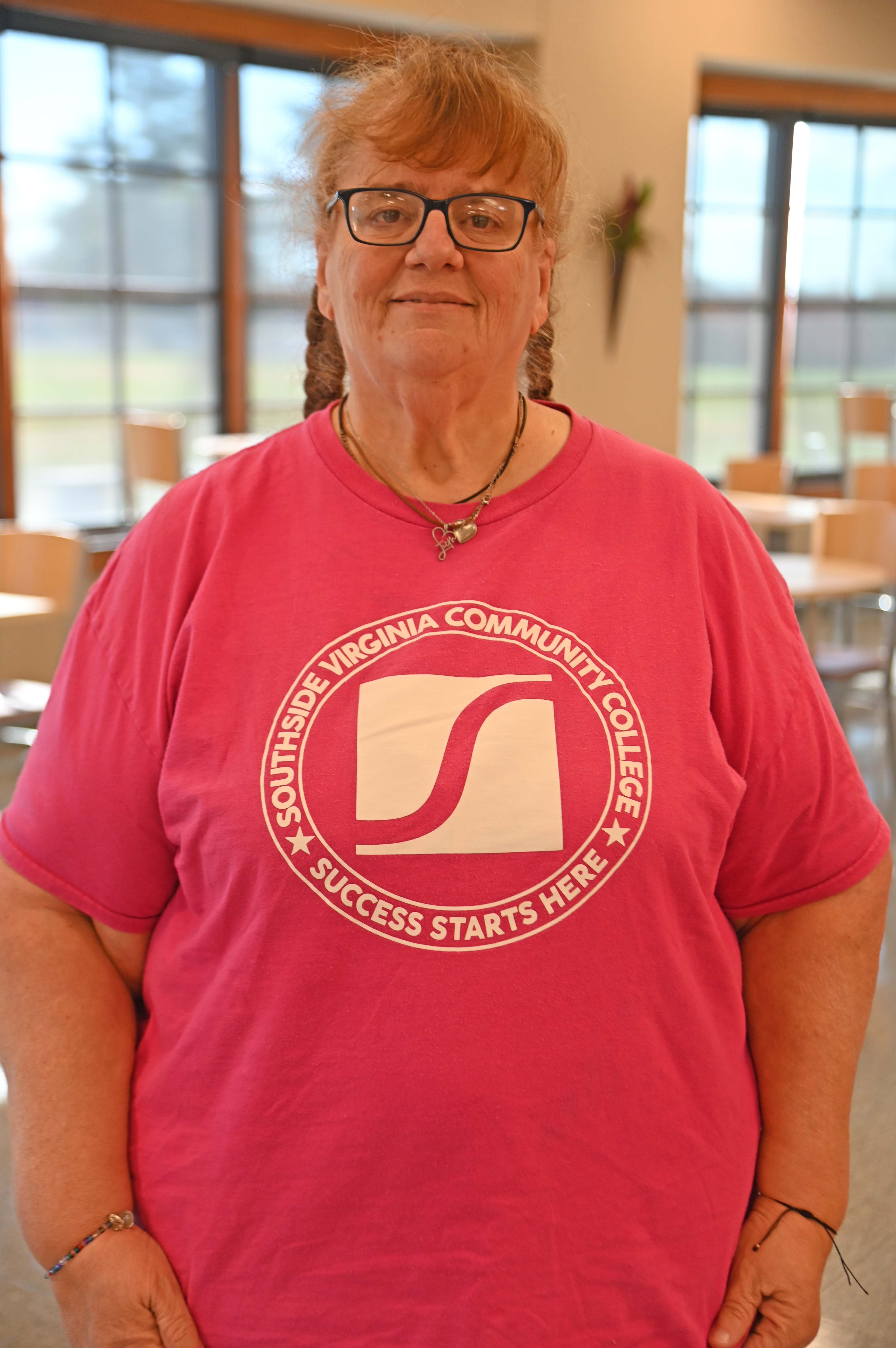 Gigi Bliss wearing a Southside tshirt posing in front of windows