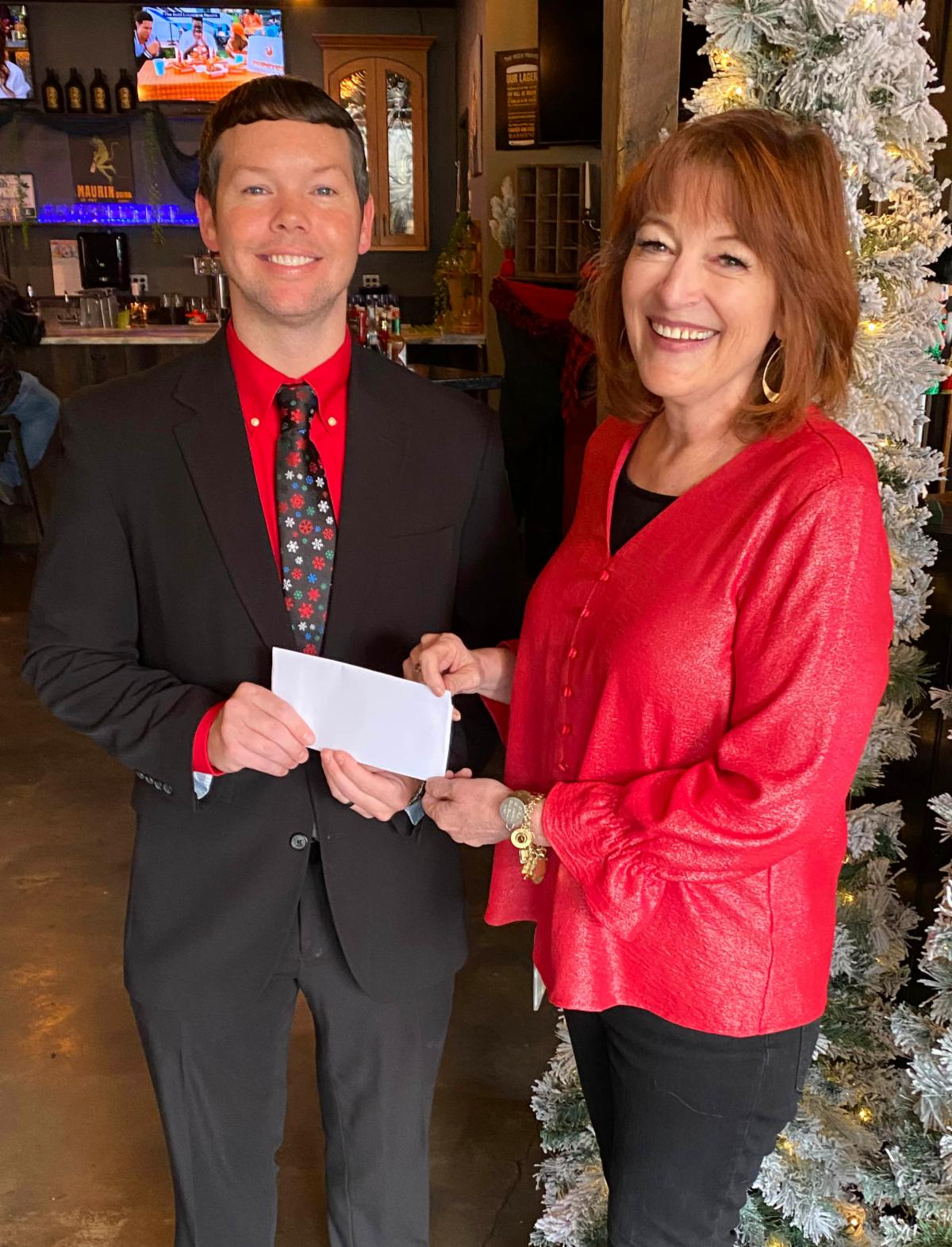 Jamie Jones accepting donation from Joy Stump 