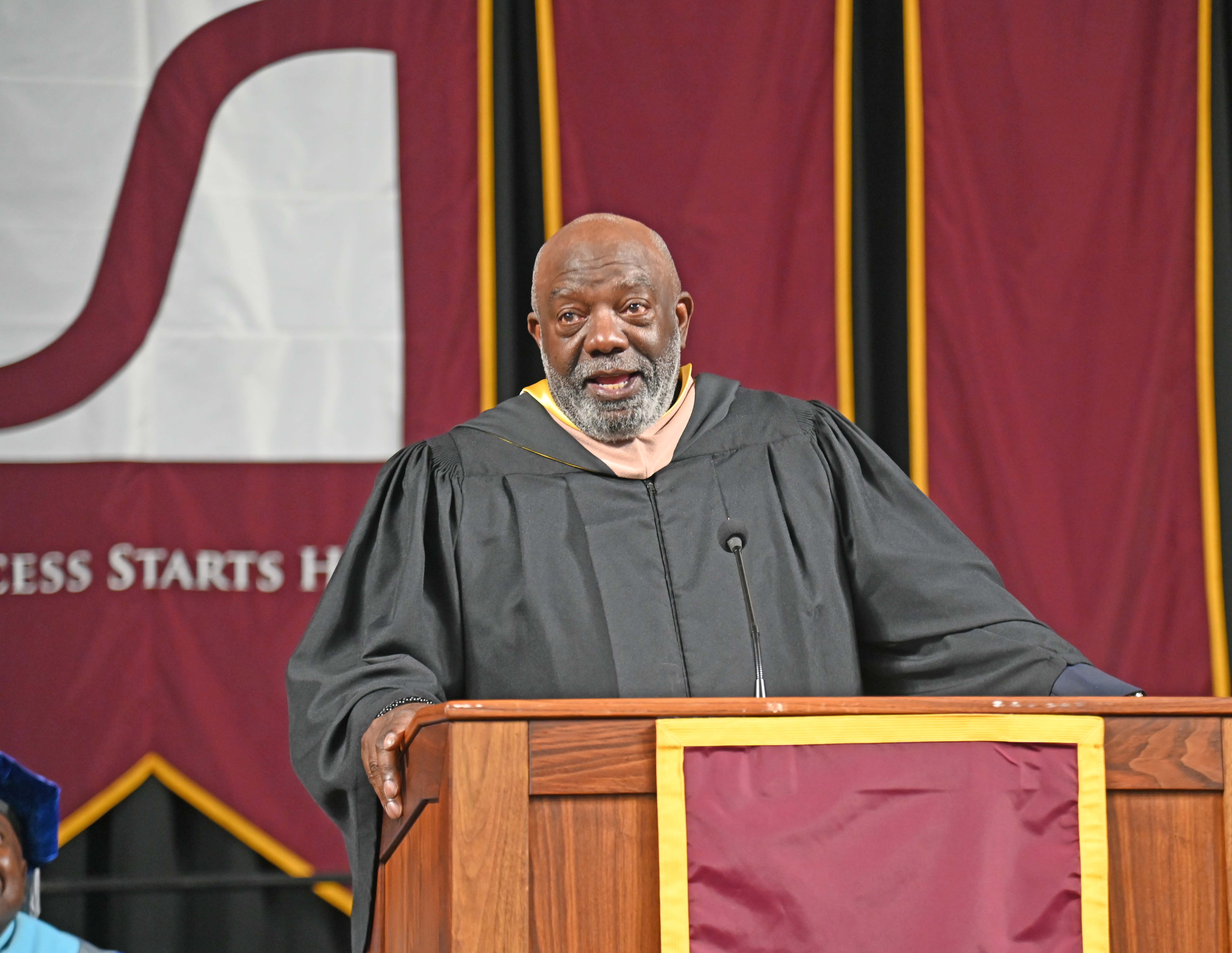 Mr. James Colon, SVCC Foundation Board Member and this year's commencement speaker at the podium in front of the SVCC banner