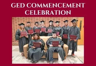 GED Commencement Celebration with group of students in graduation regalia posed