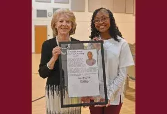 Amani Pearson accepting award from  Patricia Archer